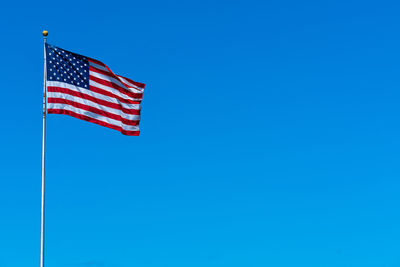 Flagstaff of united state of america on blue sky background,