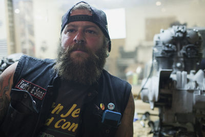 A young man leaning in a motorcycle garage