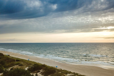 Scenic view of beach against sky during sunset