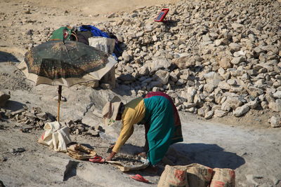 Rear view of man working on rock