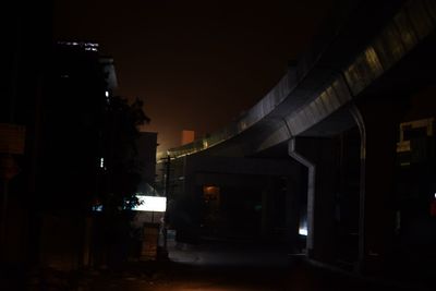 Illuminated footpath in city at night