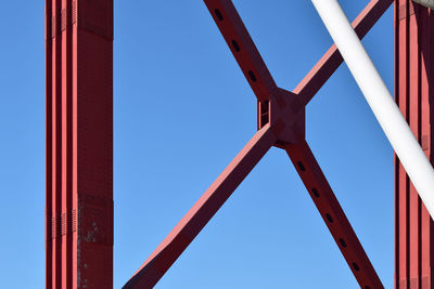 Low angle view of bridge against clear blue sky