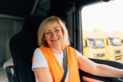 Mature woman sitting in truck