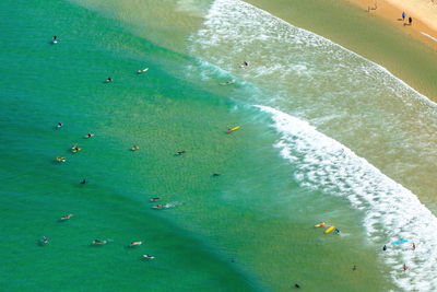 High angle view of people swimming in sea