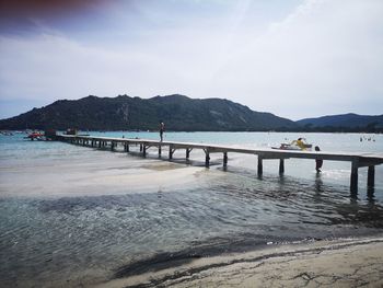 Pier over sea against sky