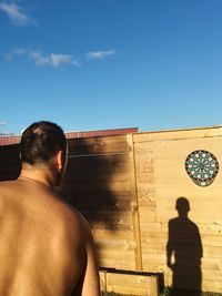 Rear view of man playing darts