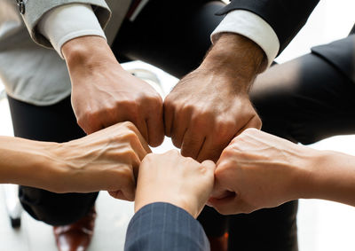 Cropped image of business persons doing fist bump