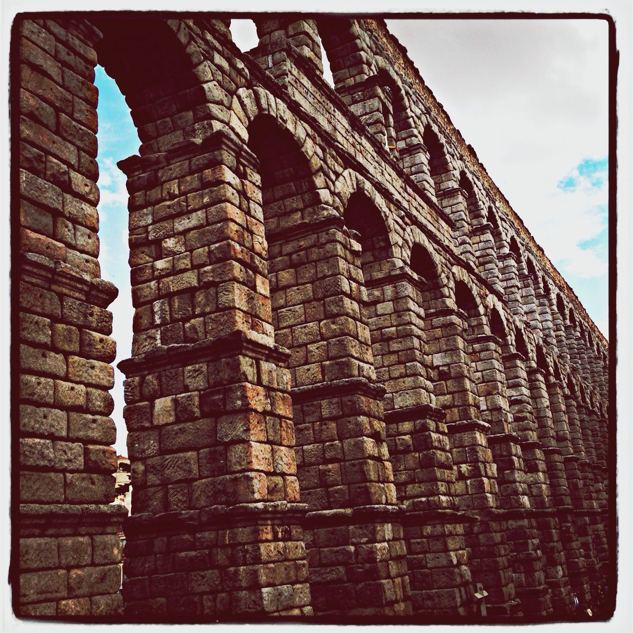 transfer print, architecture, auto post production filter, built structure, building exterior, low angle view, brick wall, history, old, stone wall, wall - building feature, sky, window, building, day, brick, outdoors, no people, pattern, arch