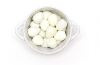 Directly above shot of eggs in bowl against white background