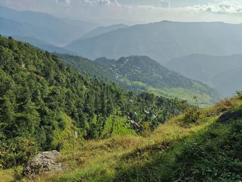 Scenic view of landscape and mountains against sky