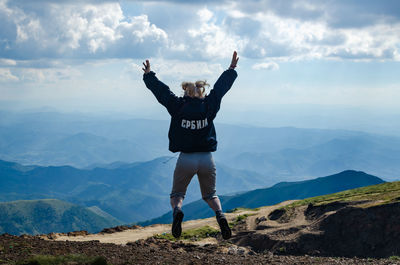 Full length of man standing on mountain against sky