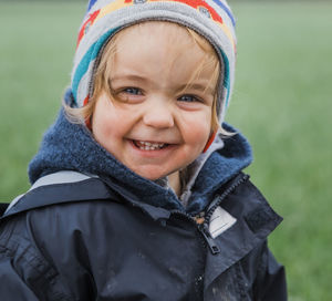 Portrait of smiling girl in warm clothing during winter