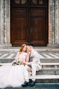 Rear view of couple holding hands