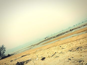 View of calm beach against clear sky