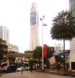 City street and buildings against sky