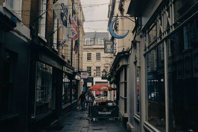 People on street amidst buildings in city