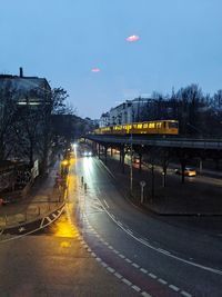 Train on railroad tracks in city against sky