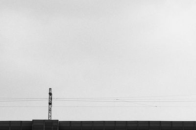 Low angle view of electricity pylon against sky