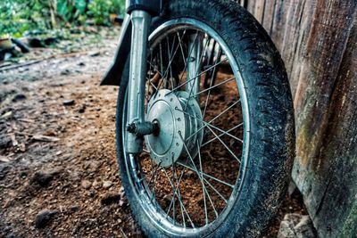 Close-up of motorcycle wheel on field