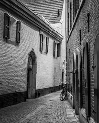 Narrow alley amidst buildings in city