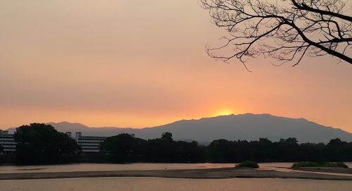 Scenic view of silhouette mountains against sky at sunset