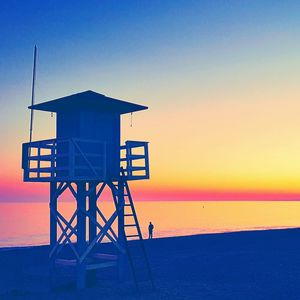 Lifeguard hut on beach against clear sky