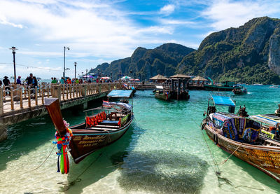 Boats moored in sea against sky