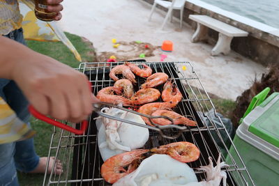 High angle view of people on barbecue grill