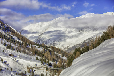 Scenic view of snowcapped mountains against sky