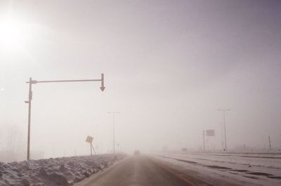 Railroad tracks against clear sky during winter