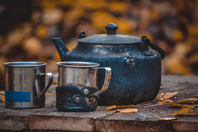 Old iron kettle and two mugs with filter