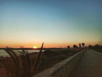 Scenic view of landscape against clear sky during sunset