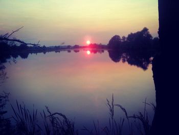 Scenic view of lake against sky during sunset