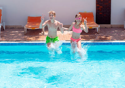 Rear view of woman swimming in pool