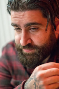 Close-up of thoughtful bearded man looking away