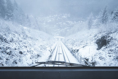 Aerial view of bridge and snowcapped mountains during winter