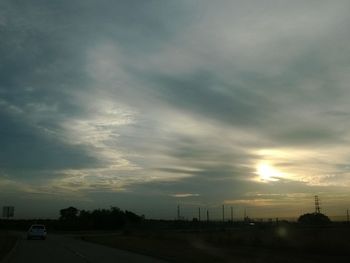 Road against cloudy sky at sunset