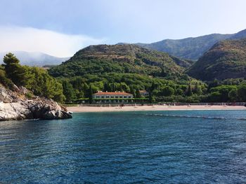 Scenic view of sea and mountains against sky