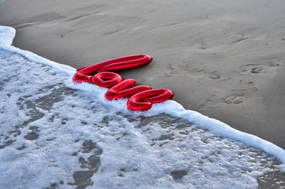 High angle view of heart shape on sand at beach