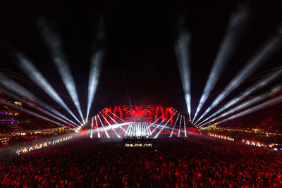 People at illuminated music concert at night