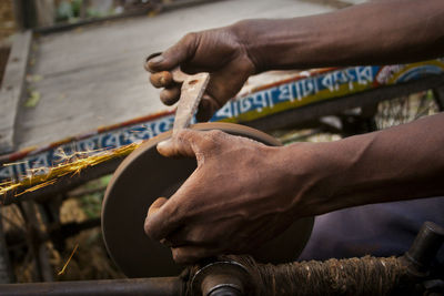 Cropped hands of man working at workshop