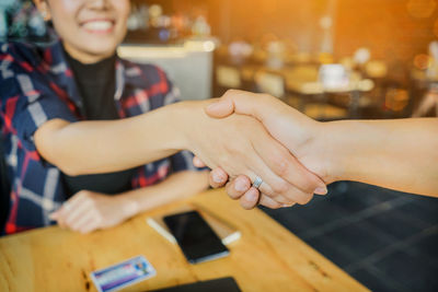 Midsection of businesswomen shaking hands