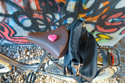 Directly above shot of bag on bicycle against graffiti wall