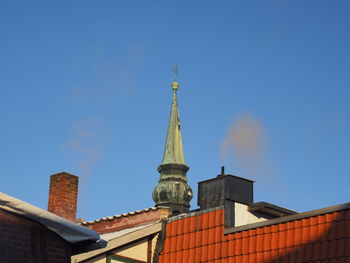 Low angle view of building against clear blue sky