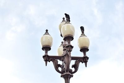 Low angle view of street light against sky