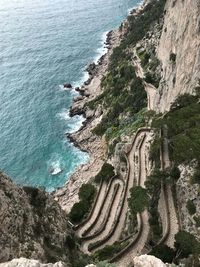 High angle view of cliff by sea