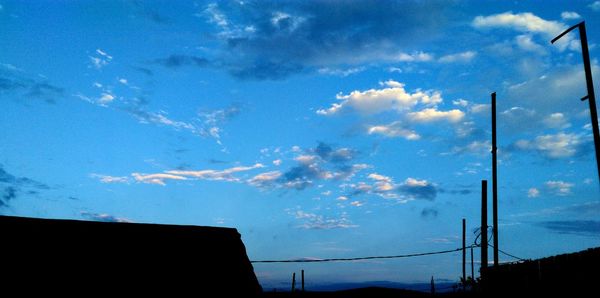 Low angle view of silhouette built structure against sky