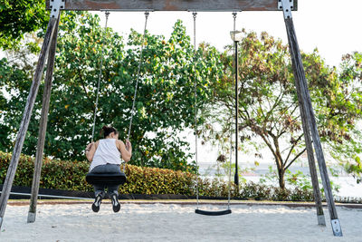 Rear view of man riding bicycle