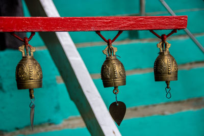 Close-up of old metal hanging against wall