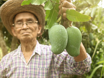 Portrait of young man with fruits